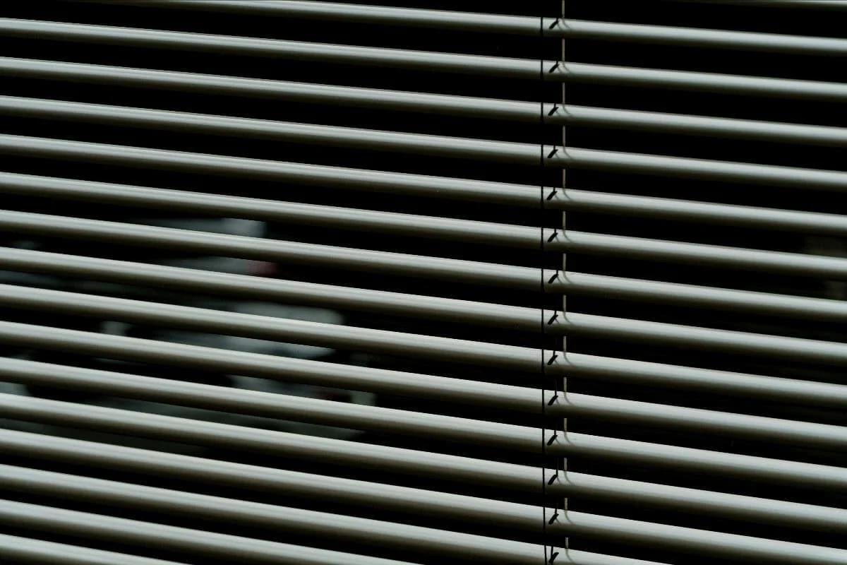 Venetian blinds shielding from the intense Oklahoma heat.